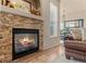 Close-up of a cozy fireplace with a stone surround and decorative mantle at 17956 Gypsum Canyon Ct, Monument, CO 80132