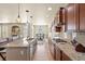 Bright kitchen showcasing stone countertops, backsplash, stainless steel appliances, and an island with bar seating at 17956 Gypsum Canyon Ct, Monument, CO 80132