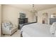 Well-appointed main bedroom featuring dark wood furnishings, a TV, and a comfortable armchair at 17956 Gypsum Canyon Ct, Monument, CO 80132