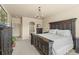 Elegantly designed main bedroom with dark wood furniture, ensuite access, and ample natural light at 17956 Gypsum Canyon Ct, Monument, CO 80132