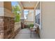 Charming porch featuring stone pillars and a cozy bench at 17956 Gypsum Canyon Ct, Monument, CO 80132