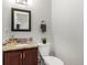A cozy bathroom with a vanity, granite counters, and dark wood cabinets at 6450 Tennyson St # 1, Arvada, CO 80003