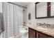 Bathroom features a bathtub, shower, tile accents, and a granite countertop vanity at 6450 Tennyson St # 1, Arvada, CO 80003