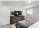 Bedroom featuring neutral tones and a rustic wooden dresser with closet at 6450 Tennyson St # 1, Arvada, CO 80003