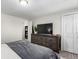 Neutral bedroom with a rustic wooden dresser and closet with double doors at 6450 Tennyson St # 1, Arvada, CO 80003