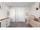 Well-lit Bedroom features a wood crib, neutral tones, and minimal decorations at 6450 Tennyson St # 1, Arvada, CO 80003