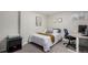 This cozy bedroom features a comfortable bed, a computer desk, and neutral decor at 6450 Tennyson St # 1, Arvada, CO 80003