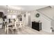 Open-concept dining area featuring a modern light fixture and decor adjacent to the home's stairway at 6450 Tennyson St # 1, Arvada, CO 80003