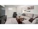 Cozy living room features a comfortable sectional sofa, entertainment center, and mini-fridge at 6450 Tennyson St # 1, Arvada, CO 80003