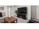 Cozy living room area with a large flat-screen TV and a wooden coffee table at 6450 Tennyson St # 1, Arvada, CO 80003
