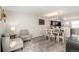 Bright living room featuring modern gray furniture and wood-look flooring adjacent to the dining area at 6450 Tennyson St # 1, Arvada, CO 80003