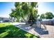 Community playground featuring a slide, climbing structure, basketball court and a large shade tree at 6450 Tennyson St # 1, Arvada, CO 80003
