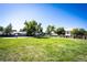 Exterior view of a community playground featuring swings, slides, basketball court and fenced perimeter at 6450 Tennyson St # 1, Arvada, CO 80003