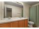 This cozy bathroom features double sinks, a large mirror, and a shower/tub combo at 581 N Flat Rock Cir, Aurora, CO 80018
