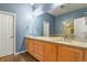 This spacious bathroom features double sinks, wood-look floors, and a separate toilet and shower area at 581 N Flat Rock Cir, Aurora, CO 80018
