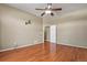 This bedroom offers a ceiling fan, hardwood floors, and neutral-colored walls at 581 N Flat Rock Cir, Aurora, CO 80018