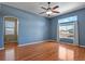 This bedroom offers a window nook, ceiling fan, hardwood floors, and an ensuite bathroom at 581 N Flat Rock Cir, Aurora, CO 80018