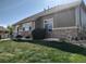 A charming home with green siding and stone accents, complemented by a well-maintained lawn at 581 N Flat Rock Cir, Aurora, CO 80018