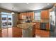 Kitchen with granite island, stainless steel appliances, and hardwood floors at 581 N Flat Rock Cir, Aurora, CO 80018