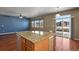 Granite kitchen island with seating overlooking the Gathering room at 581 N Flat Rock Cir, Aurora, CO 80018