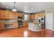 Well-equipped kitchen with granite countertops, stainless steel appliances, and wooden cabinets at 581 N Flat Rock Cir, Aurora, CO 80018