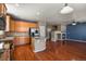 Spacious kitchen and living area featuring hardwood floors and a fireplace at 581 N Flat Rock Cir, Aurora, CO 80018