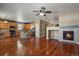 Open floor plan featuring kitchen, living area with fireplace, and hardwood floors at 581 N Flat Rock Cir, Aurora, CO 80018