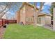 Well-maintained backyard with lush green lawn, mature trees, and a cozy patio area perfect for outdoor relaxation at 2624 S Race St, Denver, CO 80210