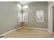 Comfortable bedroom with neutral walls, carpet flooring, and large windows fitted with classic white shutters at 2624 S Race St, Denver, CO 80210