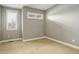 Relaxing bedroom with neutral walls, carpet flooring, and large windows fitted with classic white shutters at 2624 S Race St, Denver, CO 80210