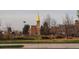 Picturesque view of a campus featuring a prominent golden spire, manicured lawns, and academic buildings at 2624 S Race St, Denver, CO 80210
