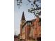 Stately clock tower set against a clear sky, surrounded by classic brick buildings and blossoming trees at 2624 S Race St, Denver, CO 80210