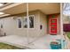 Covered porch featuring a modern red door, neutral siding, and contemporary planters at 2624 S Race St, Denver, CO 80210