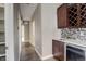 Hallway featuring hardwood floors, neutral paint, built in wine storage, and sink with modern faucet and tile backsplash at 2624 S Race St, Denver, CO 80210