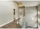 Second floor hallway with modern glass railings, wood floors, and neutral paint at 2624 S Race St, Denver, CO 80210