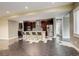 Spacious open-concept kitchen with stainless steel appliances, stylish backsplash, and a large center island with bar seating at 2624 S Race St, Denver, CO 80210
