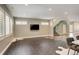 A spacious living room featuring hexagon-patterned tile floor, and an elegant staircase with glass railing at 2624 S Race St, Denver, CO 80210