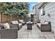An inviting back patio with modern outdoor furniture and a cozy fire pit for relaxing evenings at 23813 Broadmoor Dr, Parker, CO 80138