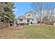 Exterior back view with a stone patio and lawn at 23813 Broadmoor Dr, Parker, CO 80138