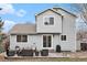 Back exterior view shows the home, patio, outdoor seating, and a well-kept lawn at 23813 Broadmoor Dr, Parker, CO 80138