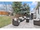 This home's backyard boasts a lush lawn, mature trees, and a comfortable patio area at 23813 Broadmoor Dr, Parker, CO 80138