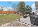 Expansive backyard featuring a well-maintained lawn, mature trees, and a charming patio area at 23813 Broadmoor Dr, Parker, CO 80138