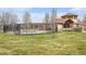 A community pool with a fence, pergola and adjacent clubhouse at 23813 Broadmoor Dr, Parker, CO 80138