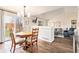 Open-concept dining area adjacent to living room with hardwood floors and natural light at 23813 Broadmoor Dr, Parker, CO 80138