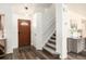 Warm and inviting entryway with hardwood floors, staircase, and stylish decor at 23813 Broadmoor Dr, Parker, CO 80138