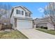 Side view of a two-story home with attached garage, showcasing the well-kept lawn at 23813 Broadmoor Dr, Parker, CO 80138