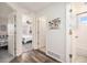 Hallway with hardwood floors leading to bedrooms and a bathroom with neutral wall color at 23813 Broadmoor Dr, Parker, CO 80138