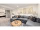 Inviting living room featuring a plush gray sectional sofa and stylish decor at 23813 Broadmoor Dr, Parker, CO 80138