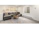 Cozy living room featuring a comfortable gray sectional sofa and a round wooden coffee table at 23813 Broadmoor Dr, Parker, CO 80138