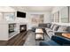 Bright living room with a cozy fireplace, sectional sofa, and stylish decor at 23813 Broadmoor Dr, Parker, CO 80138